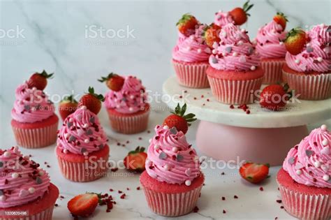 Image Of Batch Of Homemade Pink Velvet Strawberry Cupcakes In Paper