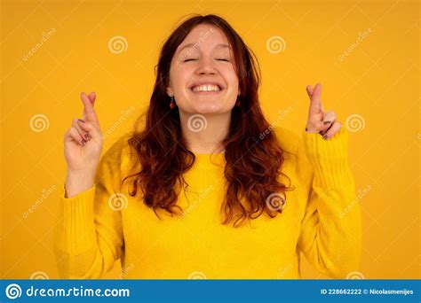 Young Woman Crossing Her Fingers Wishing Good Luck Stock Photo Image