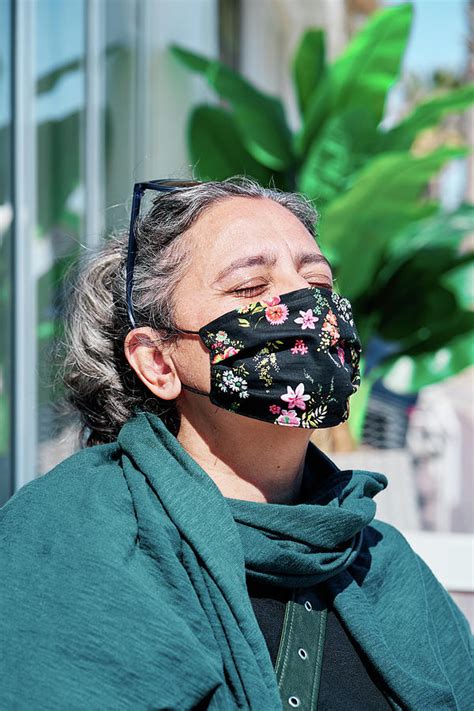 Portrait Of A Middle Aged Woman With White Hair Closed Eyes And A Mask