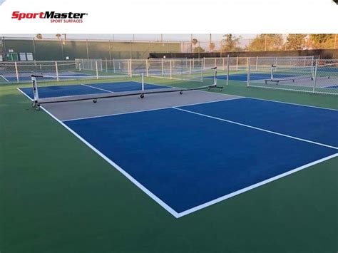 An Outdoor Tennis Court With Blue And Green Courts