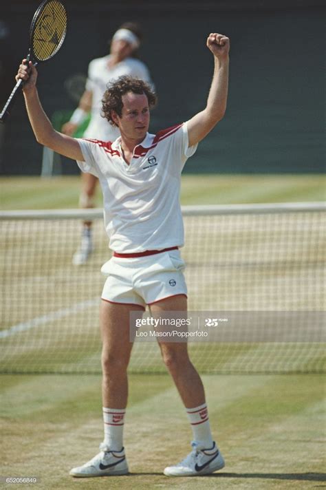 American Tennis Player John Mcenroe Raises His Hands In The Air After
