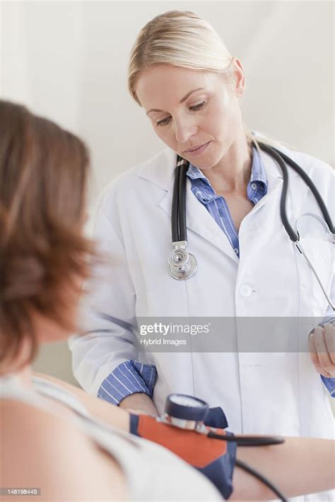 Doctor Taking Womans Blood Pressure High Res Stock Photo Getty Images