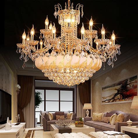A Chandelier Hanging From The Ceiling In A Living Room With Couches And