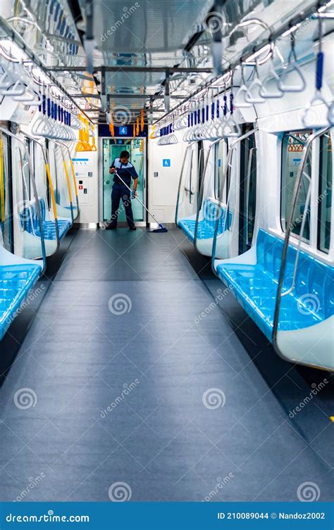 A Cleaning Service Worker Inside The Passenger Car Of The Jakarta Subway Editorial Image