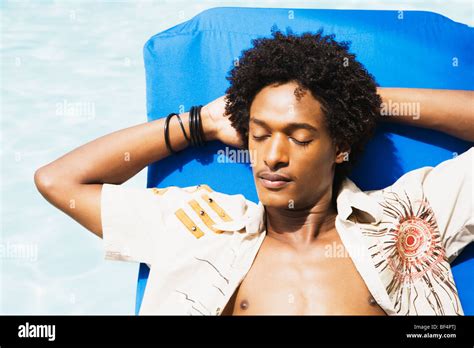 African Man Laying In Sun With Eyes Closed Stock Photo Alamy