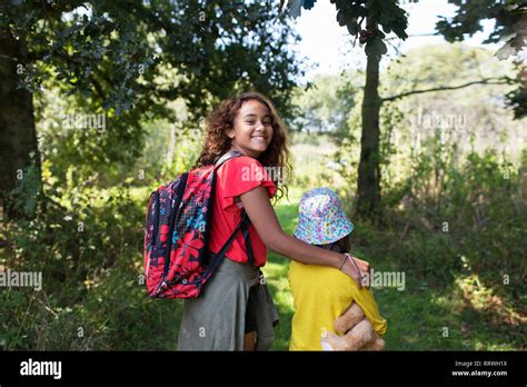 Portrait Happy Sisters Hiking Walking In Woods Stock Photo Alamy