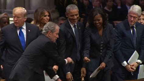 president george w bush hands piece of candy to michelle obama ahead of father s funeral