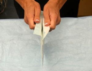 Place inner package on working surface and open up to see right and left gloves. 1.7 Surgical Hand Scrub, Applying Sterile Gloves and ...
