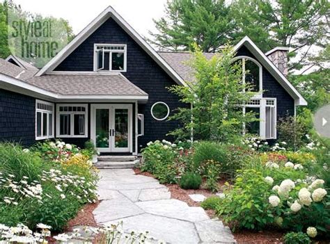 The bronze vinyl windows were provided by southern window supply. Black House Exteriors | Dans le Lakehouse