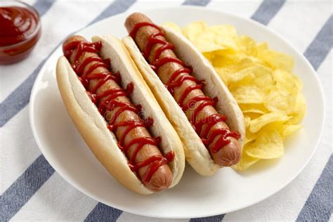 Tasty American Hot Dog With Potato Chips On A White Plate Side View