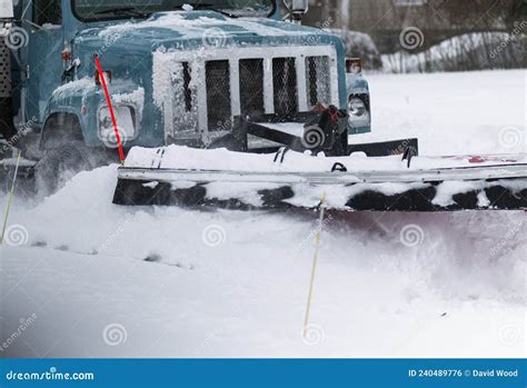 Close Up Of A Snow Plow Pushing Snow To Clear A Residential Street