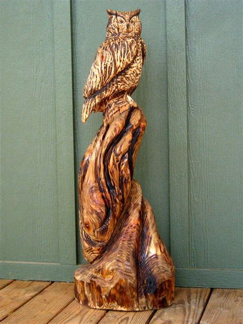 An Owl Figurine Sitting On Top Of A Wooden Floor Next To A Green Door