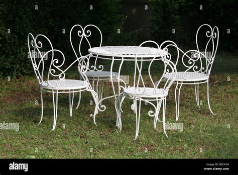 White Wrought Iron Dining Table And Chairs In Garden Stock Photo Alamy