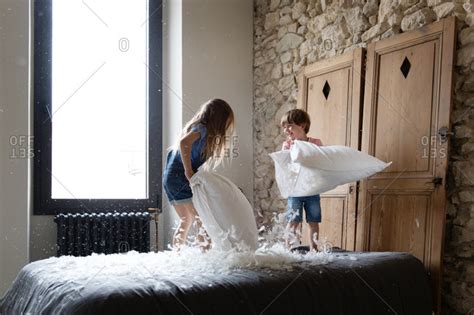 Siblings Kids Having A Pillow Fight Stock Photo Offset