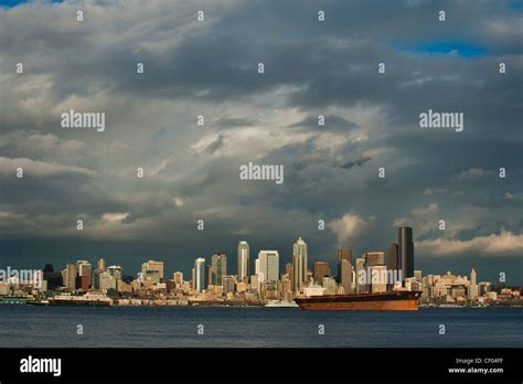 A Dramatic Sunset Highlights The Beautiful Seattle Waterfront Across