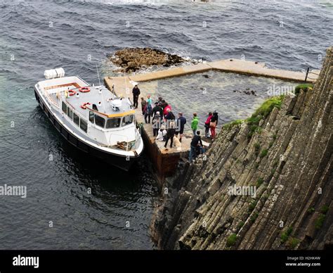 People Boarding A Tour Boat At The Landing Stage On Staffa Argyll And