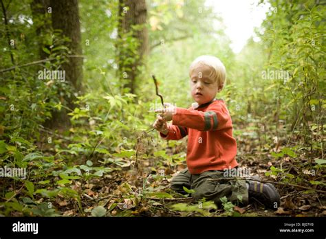 Young Boy Playing In The Woods Stock Photo Alamy