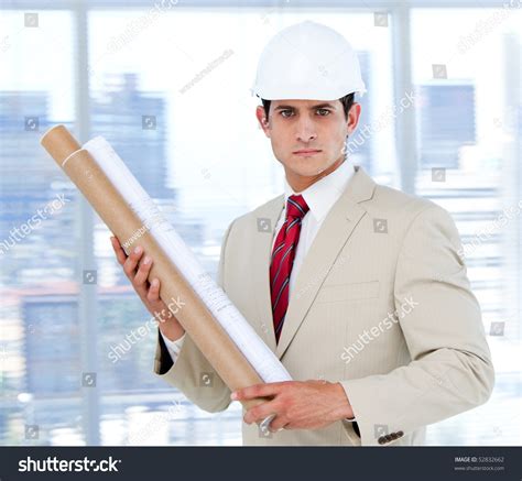 Handsome Architect Holding A Blueprint In The Company Stock Photo