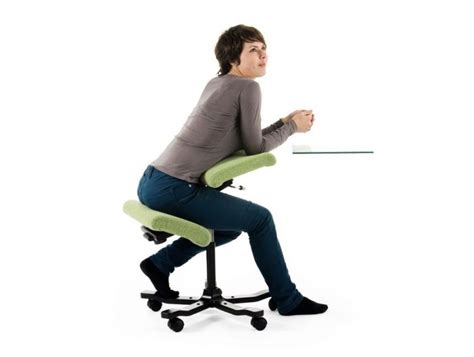 Adjustable kneeling chair with a work surface that adjusts from a flat desk to a raised easel. Varier Wing Balans Kneeling Chair