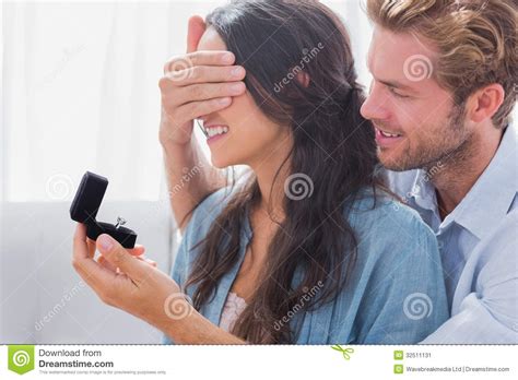 Man Hiding His Wifes Eyes To Offer Her An Engagement Ring Stock Image