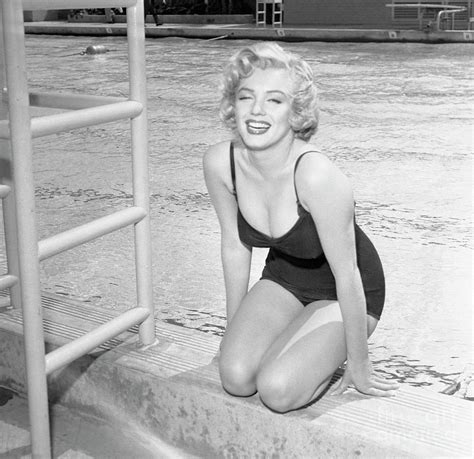 Marilyn Monroe Sitting By Pool By Bettmann