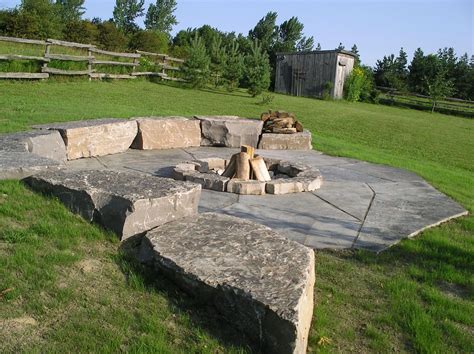 How to construct an in ground fire pit. Fire pit built into the slope with armourstone and jumbo ...