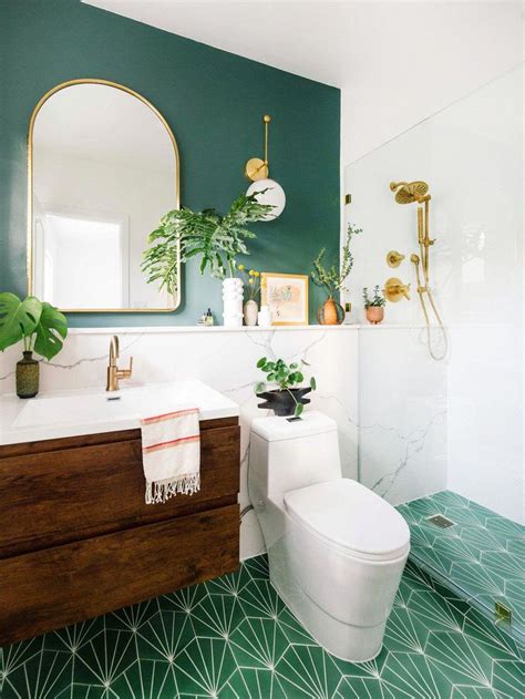 Green primary bathroom with an open shower and a freestanding tub facing the wooden vanity that's topped with a vessel sink. Gorgeous emerald green bathroom makeover with marble ledge ...
