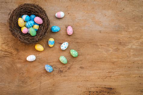 Colorful Easter Egg And Nest On A Rustic Old Wood Background Above