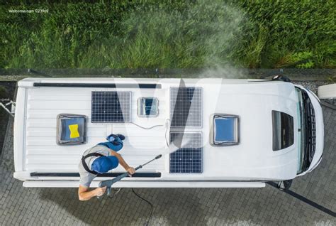 Clean the solar panels monthly. Men Pressure Washing RV Camper Van Roof Equipped with ...
