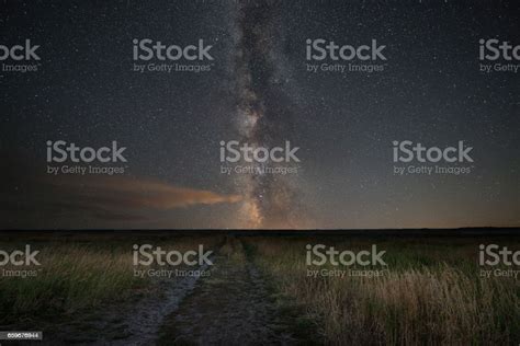 Dirt Road Leading To The Milky Way Galaxy Stock Photo Download Image