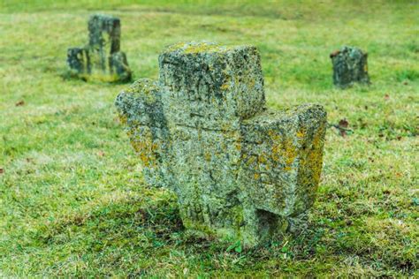 The Ancient Christian Tomb Crosses With Runes Covered With Moss And