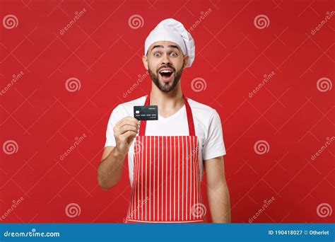 Surprised Young Bearded Male Chef Cook Or Baker Man In Striped Apron White T Shirt Toque Chefs
