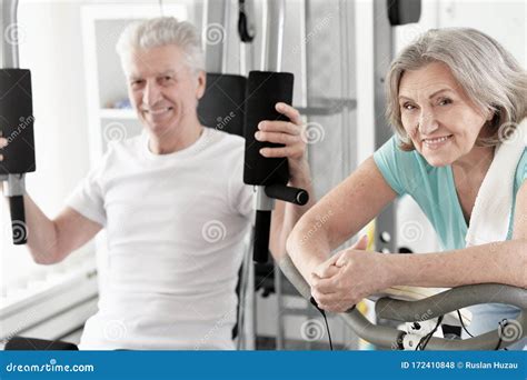 Active Smiling Senior Couple Exercising In Gym Stock Photo Image Of