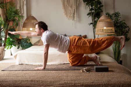 Man Practices Yoga Asana Marjariasana Or Cow Pose Or Cat Cow Pose For