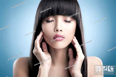 Close Up Of Tranquil Woman Rubbing Her Face Stock Photo Picture And