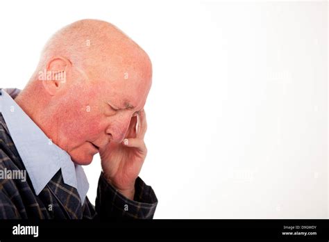 Elderly Bald Man With Is Eyes Closed And Resting His Head On His Hand