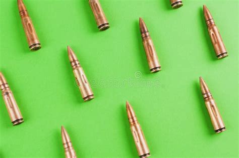 Row Of Many Bullets For Assault Rifle On Green Background Stock Photo