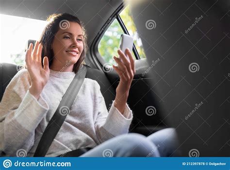 Passenger In Taxi Or Woman In Car Sitting On The Backseat Looking Outside The Window Happy
