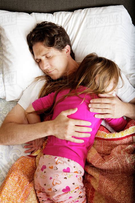 Father And Babe 6 7 Sleeping In Bed Stock Photo Dissolve