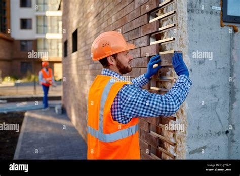 Worker Cladding Stone For External Wall Warming Stock Photo Alamy