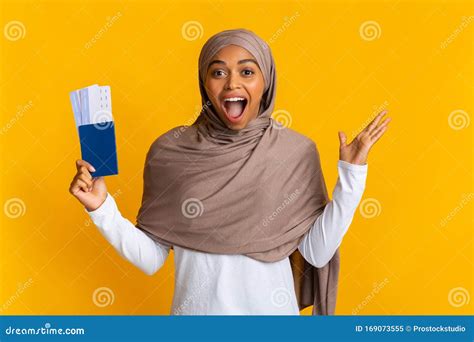 Overjoyed Black Muslim Girl Holding Passport With Tickets And Rejoicing Success Stock Image