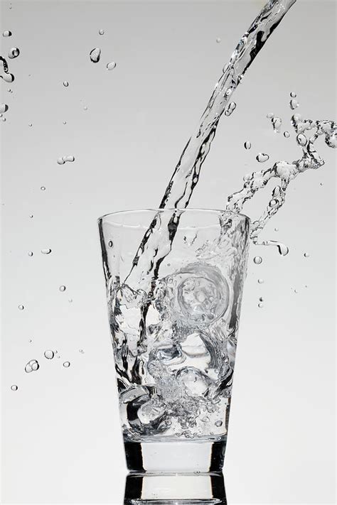 Water Being Poured Into A Glass By Dual Dual
