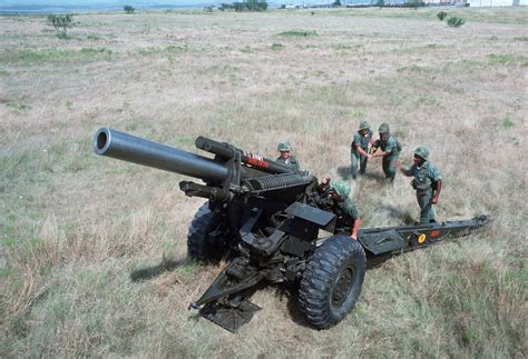 A Us Army Artillery Crew Loads An M114 155 Mm Howitzer During A