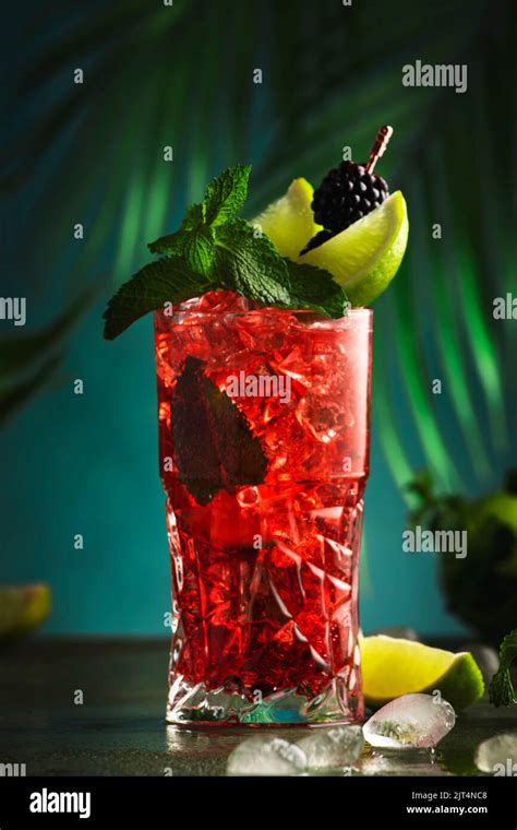 Red Alcoholic Cocktail With Bitter Whiskey Soda Lime Mint And Ice Dark Tropical Background