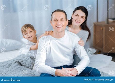 Mother And Son Posing From Behind Fathers Back Stock Image Image Of