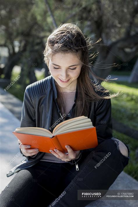Young Woman In Park Reading Book — Getting Away From It All Outdoor