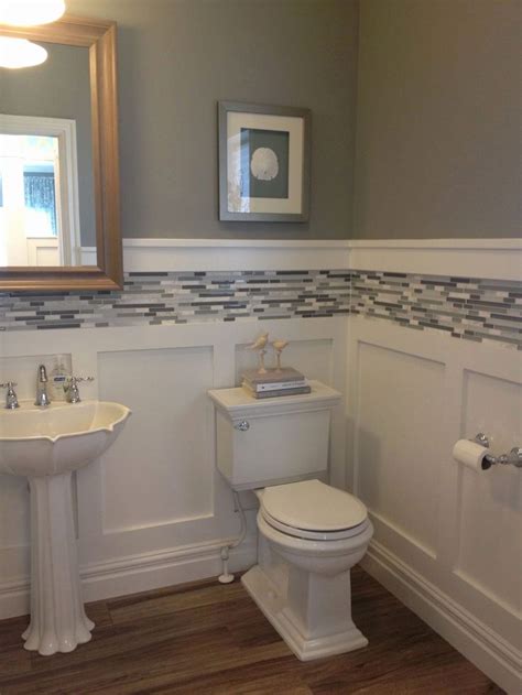 This eclectic example in a new jersey loft shows how big of an impact paneling can make when it's featured on a vanity, too. Bathroom Tile Wainscoting Ideas Elegant White Board and ...