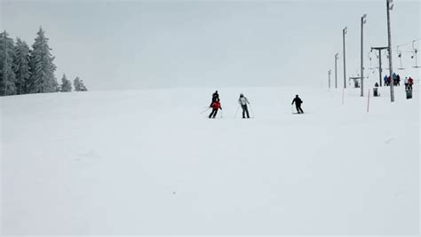 People Skiing And Snowboarding On A Snowy Ski Slope High