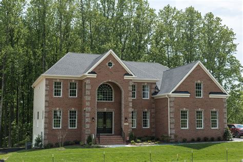 A Large Brick House With Lots Of Windows