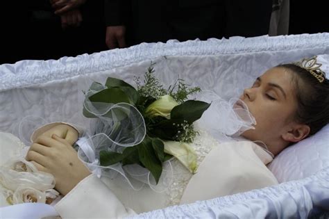You don't watch any video. Andreea Brazovan in her open casket during her funeral procession.